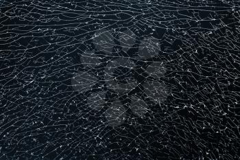 Broken strained glass with cracks and fragments. Background photo texture