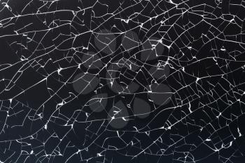 Background photo texture of broken strained glass with cracks and fragments