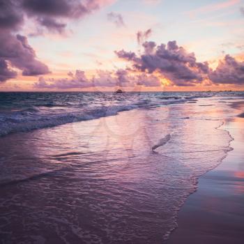 Colorful sunrise over Atlantic Ocean coast, Bavaro beach, Hispaniola Island. Dominican Republic, coastal landscape. Square photo