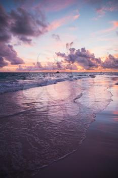 Colorful sunrise over Atlantic Ocean coast, Bavaro beach, Hispaniola Island. Dominican Republic, vertical coastal landscape