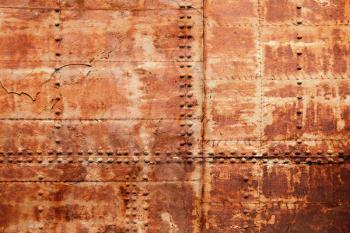 Old rusted ship hull fragment, iron sheets with rivets, background photo texture