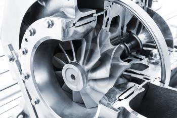 Turbocharger structure illustration with cross section, blue toned photo with soft selective focus