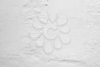 Rough white concrete wall with plaster layer pattern, background photo texture