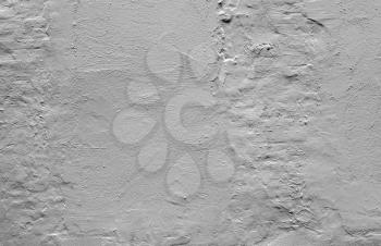 Rough gray concrete wall with plaster relief pattern, background photo texture