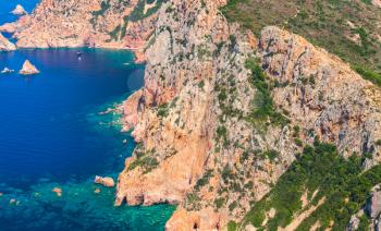Rocks and sea in summer season. Vertical landscape of French mountainous Mediterranean island Corsica. Corse-du-Sud, Piana region