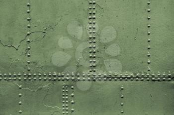 Old military green metal sheets with rivets, background photo texture