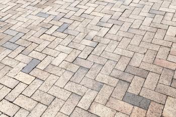 Yellow gray cobblestone pavement, background photo texture