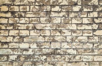 Old dirty yellow brick wall, closeup background photo texture