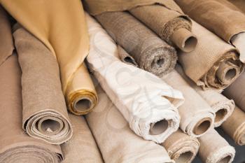 Rolls of  linen cloth lie on the market counter