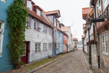 Street view with traditional colorful living houses along the street in old Flensburg, Germany