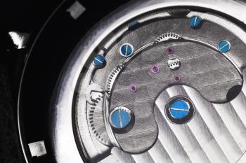 Mechanical luxury men wrist watch with automatic winding, close-up fragment of open back side with self-winding mechanism details
