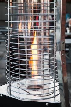 Outdoor gas heater burns on restaurant terrace 