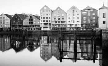 Coast of Nidelva river. Traditional wooden houses in old town of Trondheim, Norway. Black and white photo