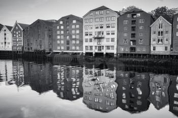Coast of Nidelva river. Wooden houses in old town of Trondheim, Norway. Black and white