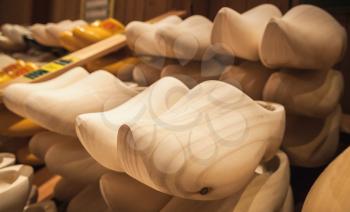 Uncolored clogs made of poplar wood. Klompen, traditional Dutch shoes for everyday use stand in a row
