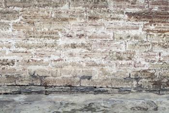 Old wall made of concrete blocks and asphalt pavement, abstract empty interior background texture