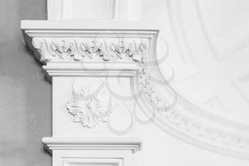 Column with stucco relief molding, abstract white interior in classical style