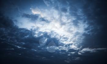 Dark blue night dramatic sky with stormy clouds, abstract nature background photo