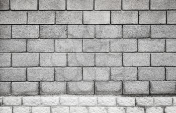 Stone wall made of gray foam concrete blocks, flat background photo texture