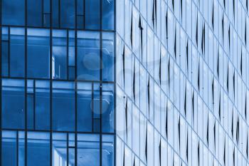 Modern office building corner, blue glass and steel frames