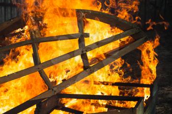 Burning wooden structure, outdoor bonfire background