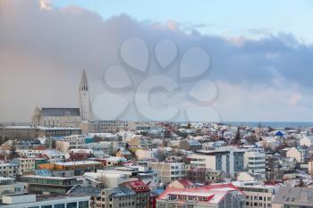 Reykjavik, capital city of Iceland. Cityscape with modern buildings and Hallgrimskirkja church under cloudy sky