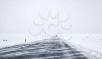 Icelandic road covered with snow, empty winter landscape