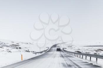 Icelandic road covered with snow, rural winter landscape