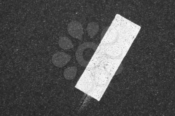 White rectangle on dark gray tarmac, highway road marking. Abstract transportation background texture