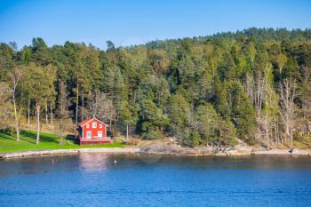 Swedish rural landscape, coastal village with red wooden house