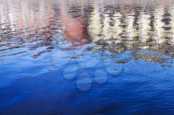 Ripple water surface with old buildings reflections. Fontanka river of Saint-Petersburg, Russia