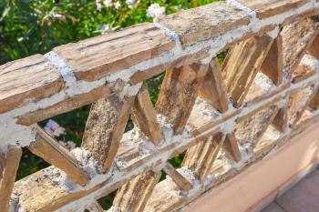 Old balcony railings made of clay blocks, Greek style architecture details, close up 