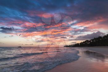 Colorful sunrise over Atlantic Ocean coast. Bavaro beach, Hispaniola Island. Dominican Republic, coastal landscape