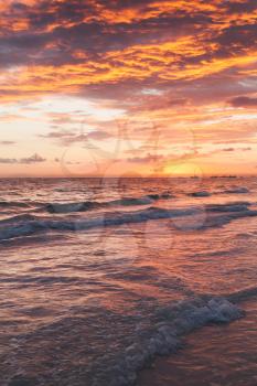 Colorful sunrise over Atlantic Ocean coast. Bavaro beach, Hispaniola Island. Dominican Republic, vertical coastal landscape