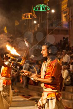 VARANASI, INDIA - APRIL 11: An unidentified Hindu priest performs religious Ganga Aarti ritual (fire puja) at Dashashwamedh Ghat on April 11, 2012 in Varanasi, Uttar Pradesh, India