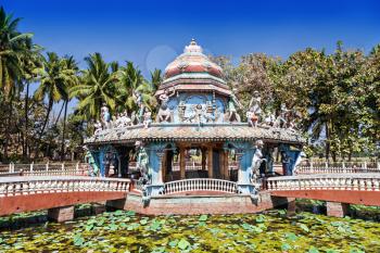 Beauty hindu temple stands on pond with lillies