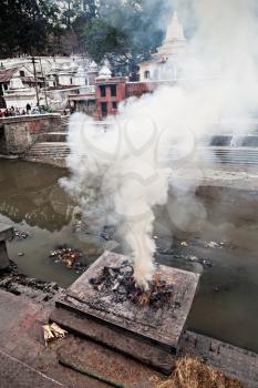 KATHMANDU - APRIL 15: Cremation ceremony along the holy Bagmati River at Pashupatinath Temple complex, April 15, 2012 in Kathmandu, Nepal. This is the most sacred place to all Hindus in Nepal.