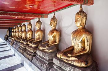 Golden Buddha statues in Wat Pho Temple - Buddhist temple complex in Bangkok, Thailand