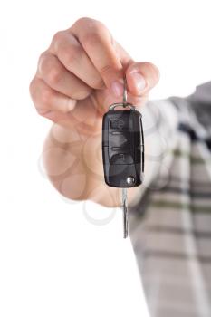 Male hand giving you car key. Isolated on white