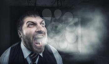 Angry businessman screaming over gray background