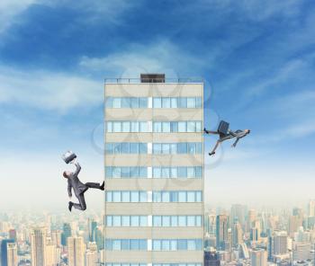 Businessman and businesswoman running to the top of a high building