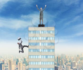 Businessman going to the top of the building and businesswoman triumphes