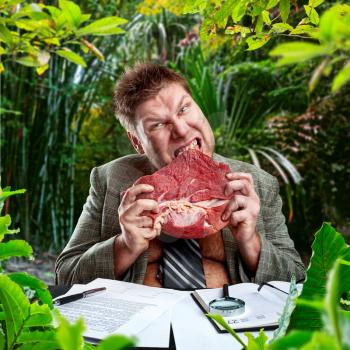 Predator businessman eating raw meat in jungles
