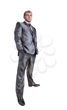Standing confident businessman with hands in pockets. Isolated on white