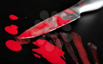 Close-up of knife in blood