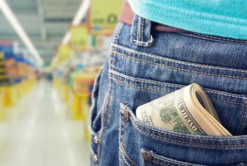 Closeup of money in the pocket against grocery market