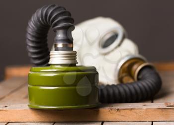 Closeup of old gas mask on wooden box