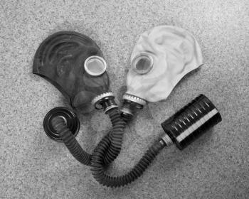 Loving couple of gas masks looking at each other