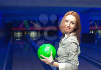 Beautiful woman in a bowling alley having fun
