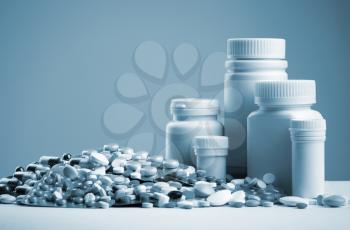 Various pills, capsules, dragee and white bottles. Toned
